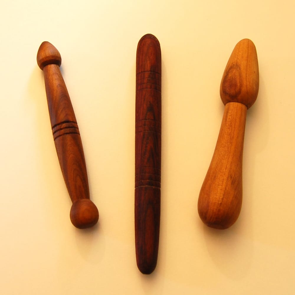 Three smooth wooden Thai massage sticks