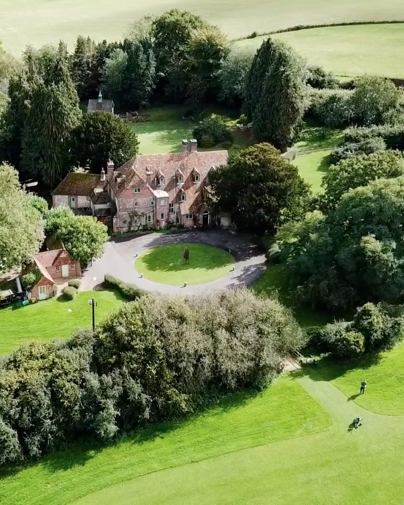 Aerial view of the Riversdown Estate – the house and grounds set among trees and lawns in the Meon Valley